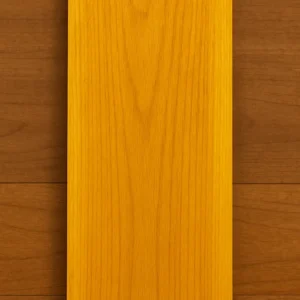 Osage Orange hardwood lumber board with a rich golden-yellow tone and fine grain detail.
