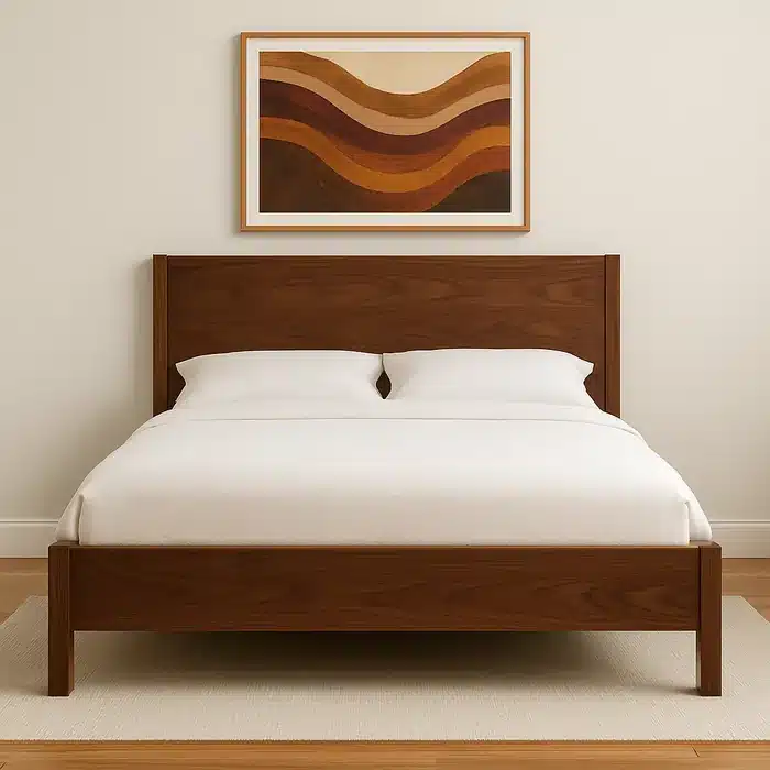 Black walnut bedframe with a simple panel headboard and white bedding beneath a warm abstract wall art piece.