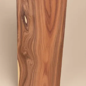 Bolivian rosewood (Morado) hardwood board with flowing brown and violet grain on a warm neutral background