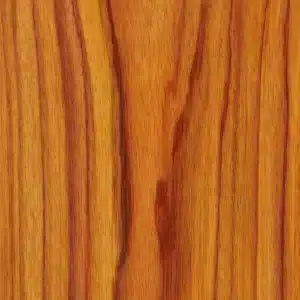 Close-up of Canarywood lumber showing warm golden-orange grain with darker streaks and a smooth, even texture.