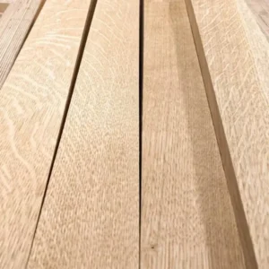 Close-up of rift and quartersawn White Oak boards neatly laid out on a workbench at G&H Hardwoods