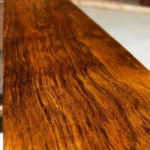 Close-up of a Jatoba Brazilian cherry hardwood board with rich orange-brown color and flowing grain at G&H Hardwoods in Auburn, WA