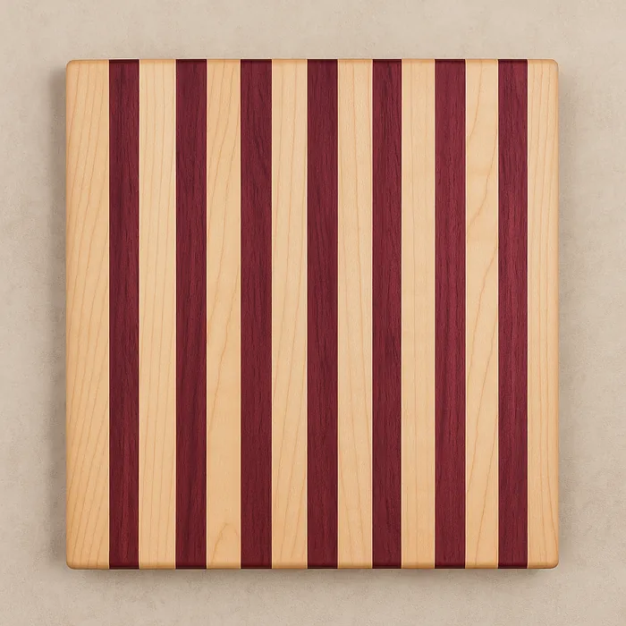 Top-down view of a striped cutting board made from hard maple and purpleheart with rounded corners.